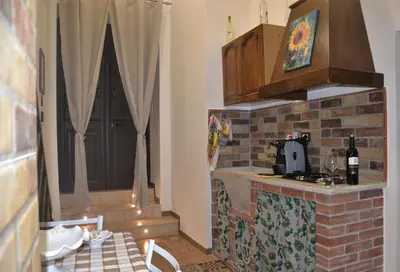 a kitchen with a counter and a brick wall at Casa Del Vicolo Apartament in Palermo