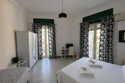 a bedroom with a bed with two towels on it at Cosmopolitan Palermo in Palermo