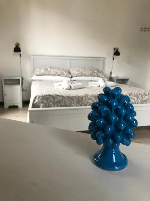 a bedroom with a bed with two pillows on it at Cosmopolitan Palermo in Palermo