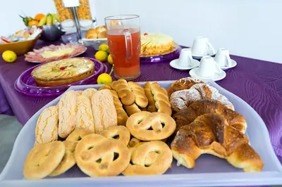a plate of bread and pastries on a table at Le Camere del Crimiso in Castellammare del Golfo