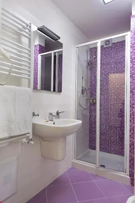 a bathroom with a sink and a shower with purple tiles at Le Camere del Crimiso in Castellammare del Golfo