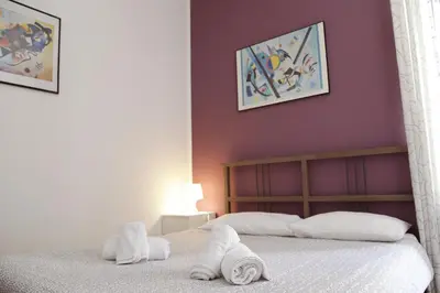 a bedroom with a bed with towels on it at Bahlara Case Vacanza in Palermo
