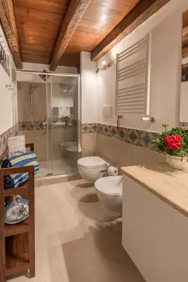 a bathroom with two toilets and a glass shower at Il Glicine La Piana dei Colli in Mondello