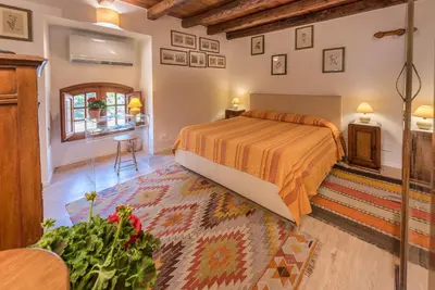 a bedroom with a king sized bed in a room at Il Glicine La Piana dei Colli in Mondello