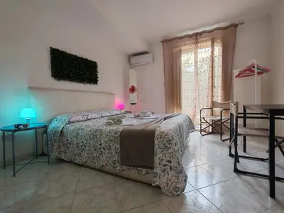 a white bedroom with two towels on a bed at 4 passi Casa Vacanza in Palermo