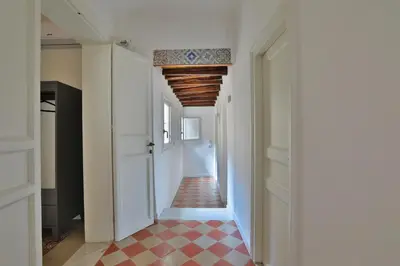 a hallway with a red and white checkered floor at Storie di Palermo in Palermo