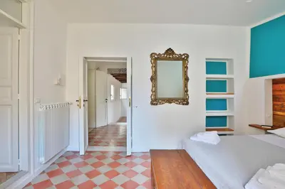 a bedroom with a bed and a mirror on the wall at Storie di Palermo in Palermo
