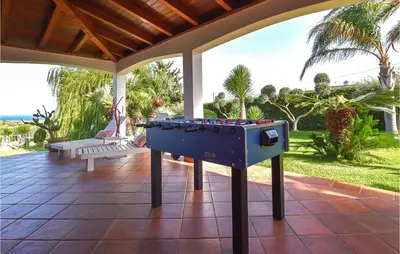 a ping pong table on a patio at Villa Musasealdoge in Partinico