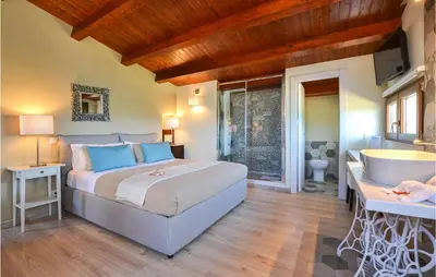 a bedroom with a bed and a tub and a sink at Villa Musasealdoge in Partinico