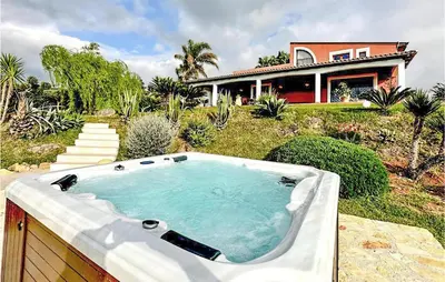 a bath tub in front of a house at Villa Musasealdoge in Partinico