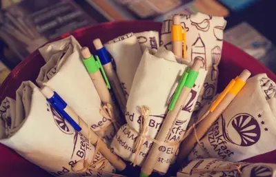 a red bowl filled with pens and pencils at Bed & Breakfast Tiziana in Castellammare del Golfo