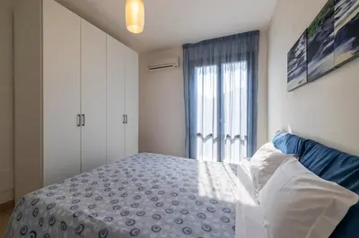 a bedroom with a bed and a window at Casa Vacanza Azzurra in San Vito lo Capo