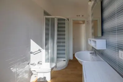 a bathroom with a sink and a toilet and a tub at Casa Vacanza Azzurra in San Vito lo Capo