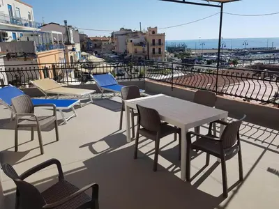 a group of tables and chairs on a balcony at Mondello vista in Mondello