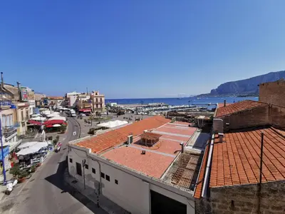 a view of a city with the ocean in the background at Mondello vista in Mondello