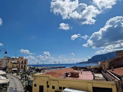 a view of the beach from a city street at Mondello vista in Mondello