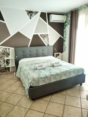 a bedroom with a bed with two towels on it at Casa vacanze Isolotto in Isola delle Femmine