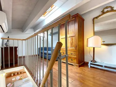 a living room with a couch and a mirror at Solemar Sicilia - Casa Maria in Santa Flavia