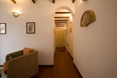 a hallway with an archway and two chairs in a room at Aziyz Camere in Castellammare del Golfo
