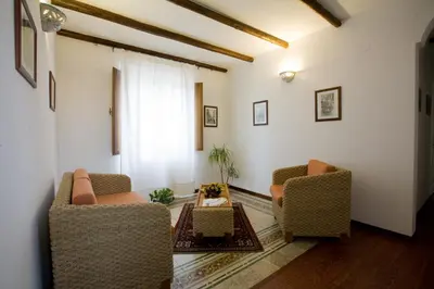 a living room with two chairs and a table at Aziyz Camere in Castellammare del Golfo