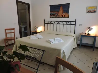 a bedroom with a bed with towels on it at Aziyz Camere in Castellammare del Golfo