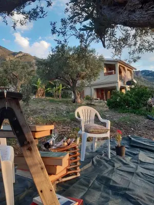 a patio with a chair and a table at Villa Calcasacco in Termini Imerese