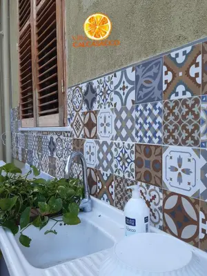 a bathroom with a sink and a tiled wall at Villa Calcasacco in Termini Imerese