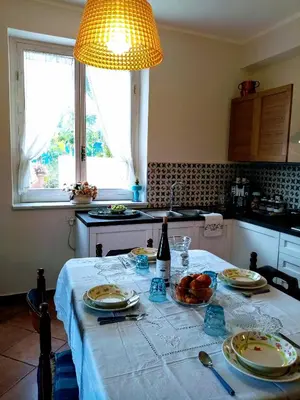 a kitchen with a table with food and a bottle of wine at Villa Calcasacco in Termini Imerese