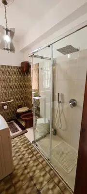 a bathroom with a glass shower with a toilet at Villa Calcasacco in Termini Imerese