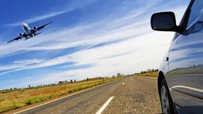 a plane flying over a road with a car at TerraSole Bakery B&B in Terrasini