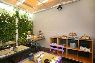 a restaurant with two tables and a shelf of food at TerraSole Bakery B&B in Terrasini