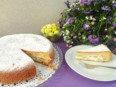 two slices of cake on plates on a table with flowers at TerraSole Bakery B&B in Terrasini