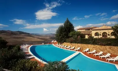 a swimming pool with lounge chairs and a house at Villa Dafne in Alia