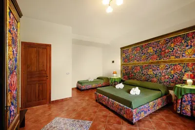 a living room with two green couches and two tables at Villa Dafne in Alia