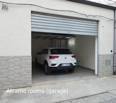 a white car is parked inside of a garage at Alcamo Rooms con GARAGE privato in Alcamo