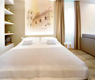 a large white bed in a room with a window at BURNÌA Sicily Holiday House in Palermo