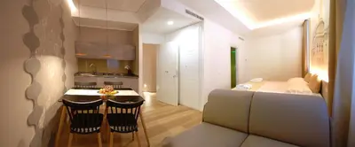 a kitchen with a table and two chairs in a room at BURNÌA Sicily Holiday House in Palermo