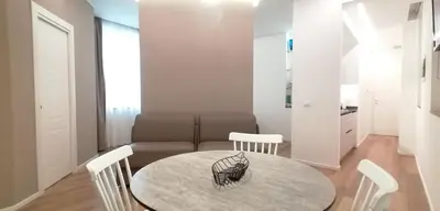 a living room with a table and a couch at BURNÌA Sicily Holiday House in Palermo