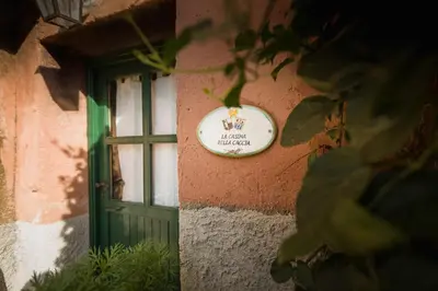 a sign on the side of a building with a window at Masseria Pernice in Monreale
