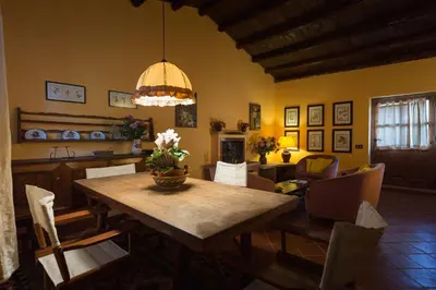 a living room with a dining room table and a dining room at Masseria Pernice in Monreale
