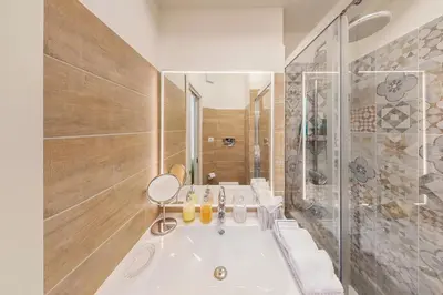 a bathroom with a large tub and a shower at Maison de Famille in Palermo