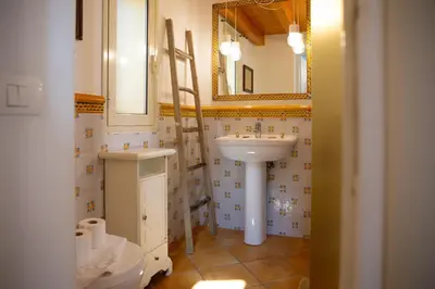 a bathroom with a sink and a mirror at Solemar Sicilia - Casa Olivia in Santa Flavia