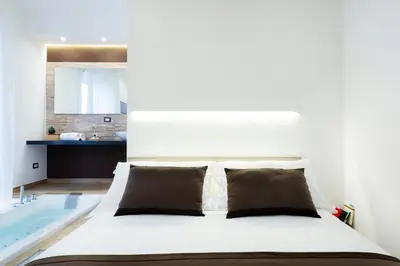 a bedroom with a bed and a bath tub at Lighea aqua suites and breakfast in Palermo