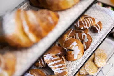 a bunch of donuts with icing on a tray at Lighea aqua suites and breakfast in Palermo