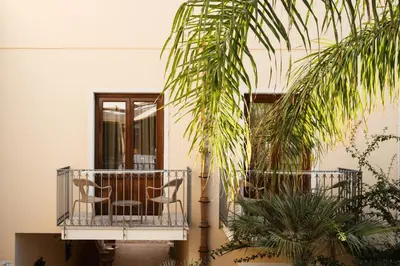 a patio with a chair on a balcony at Hotel Tannure in San Vito lo Capo