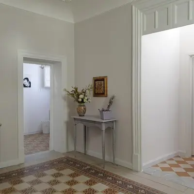 a room with a couch and a table and a mirror at Opera Prima 28 in Palermo