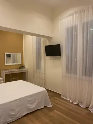 a bedroom with a white bed and a window at Alemar Bed & Breakfast in Mondello