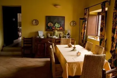 a dining room with a table and chairs and a dining room at Agriturismo Ridocco in Corleone