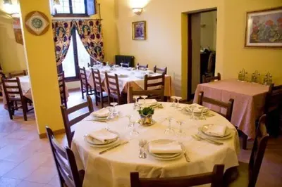 a dining room with tables and chairs with white tablecloths at Agriturismo Ridocco in Corleone
