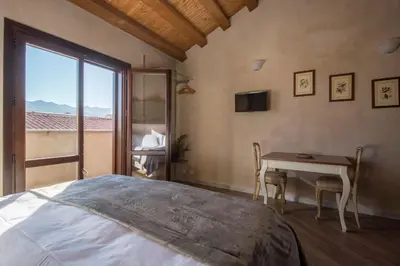 a bedroom with a bed and a table and a window at Conte Federico Apartments in Palermo